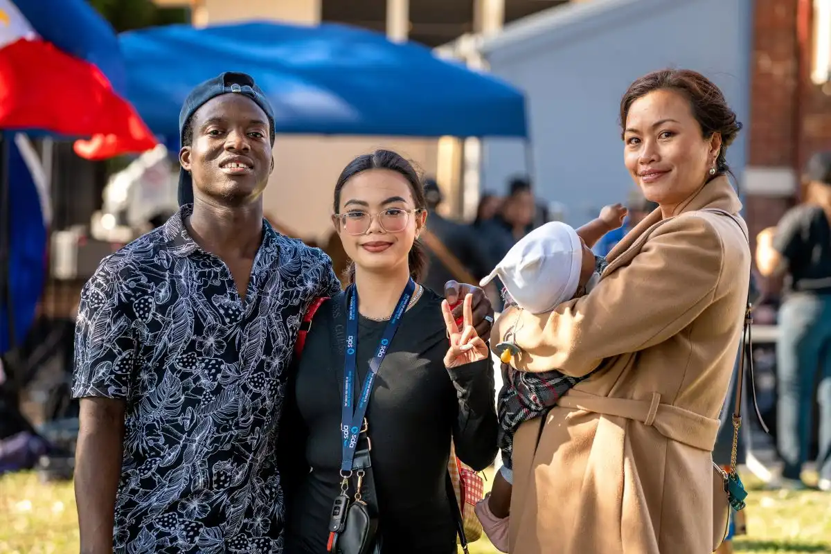 A group of people standing together outdoors at an event.